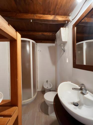 a bathroom with a white toilet and a sink at I Normanni in Trapani
