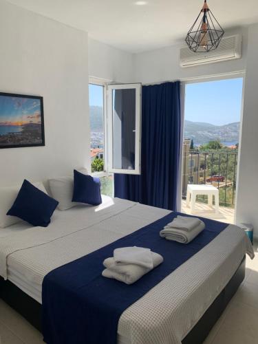 a bedroom with two beds and a large window at Lizo Hotel in Kalkan