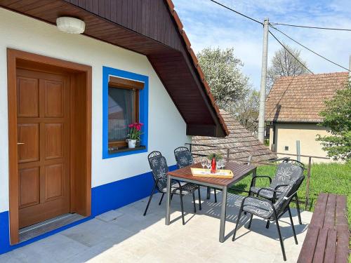 a patio with a table and chairs in front of a house at Apartmán Na vinařské stezce in Velké Bílovice