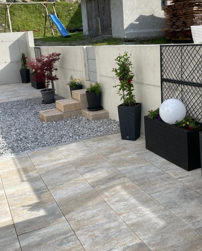 a patio with potted plants and a fence at Alpenresidenz M Vermietungs KG in See