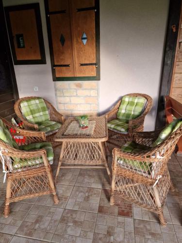 a group of wicker chairs and tables on a patio at Medjedovica Brdo Godovik in Godovik