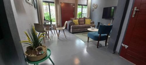 a living room with a couch and a table at Zachi Apartments in Kitwe