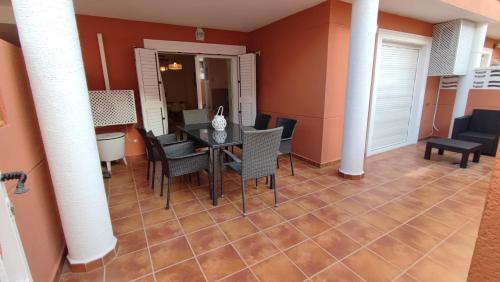 a dining room with a table and chairs at Apartamento planta baja con piscina in Denia
