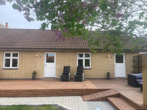 a patio with two chairs and a house at Randalín in Åkirkeby