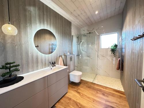 a bathroom with a sink and a toilet and a shower at Luxury and Modern Cabin on the Golden Circle in Miðdalur