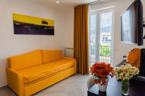 龐貝的住宿－Palazzo Archeo，客厅设有黄色的沙发和窗户。