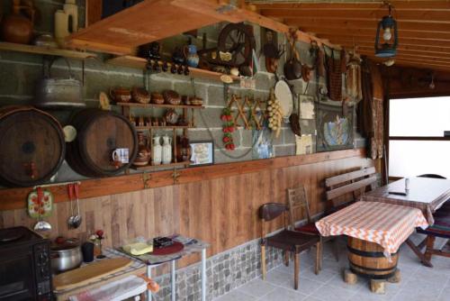a kitchen with a table and some pots and pans at Роден Край Homeland in Sopot