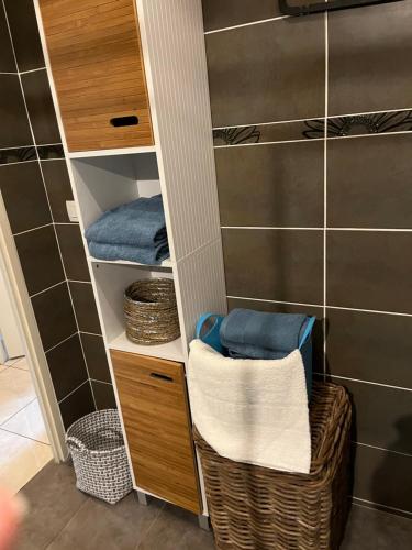 a walk in closet with a basket and towels at Charme et calme in Marseille