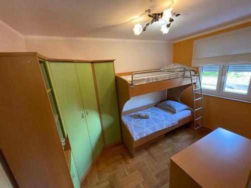 a room with two bunk beds and a table at Villa Maja in Trogir