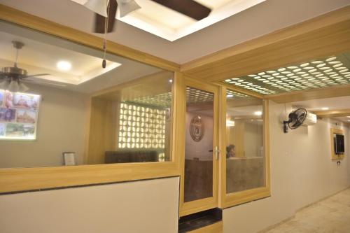 a living room with a window and a ceiling at Hotel 7-B in Chhatarpur