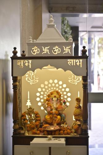 a display of a temple with a deity on it at Hotel 7-B in Chhatarpur
