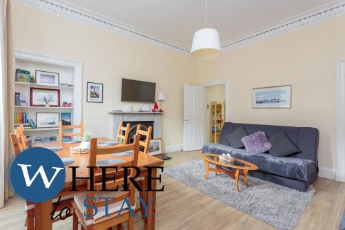 a living room with a couch and a table at Beautiful 2Bed Ground-F Pitt St. Apartment in Edinburgh