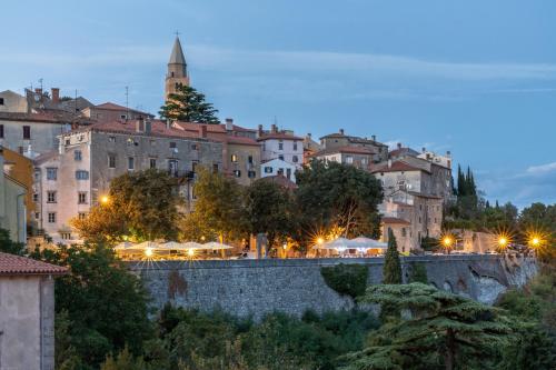 a city at night with buildings and a bridge at Canova Apartment in Labin