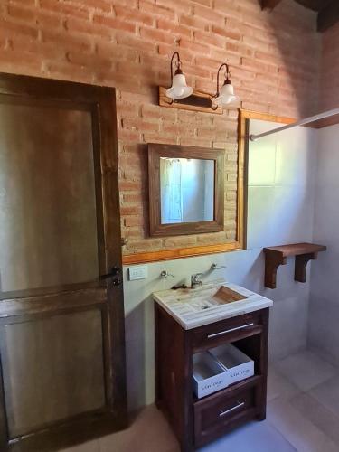 a bathroom with a sink and a mirror at Cabaña Flor de Lis in San Javier