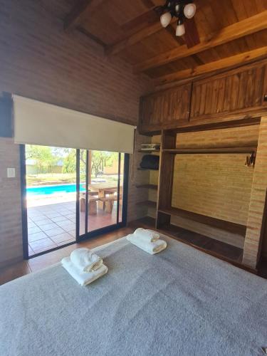 a bedroom with a bed with two towels on it at Cabaña Flor de Lis in San Javier