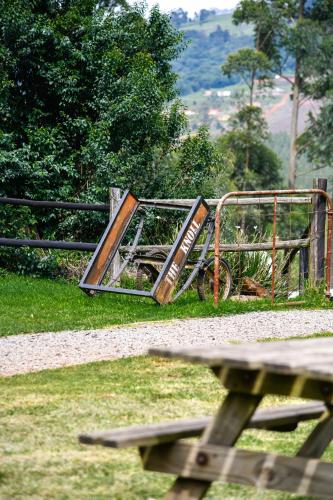 a wooden sign sitting next to a picnic table at The Knoll Historic Guest Farm in Hilton