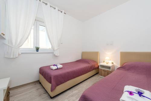 Ένα ή περισσότερα κρεβάτια σε δωμάτιο στο Villa Mirta