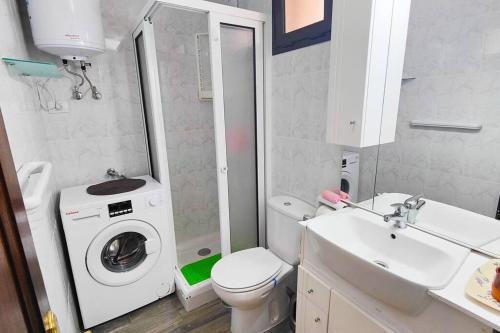 a bathroom with a washing machine and a washer at Sweet Flat with private patio Dunasol in Corralejo