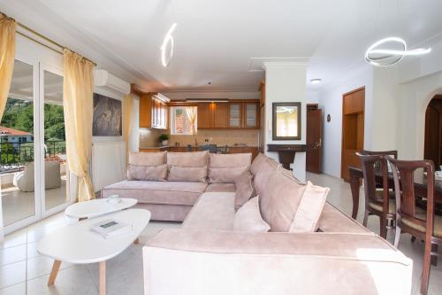 a living room with a couch and a table at Adria Luxury Apartments in Nydri