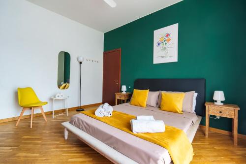 1 dormitorio con 1 cama con paredes amarillas y verdes en [Casa Graziola] Wi-Fi, Netflix, 5* Comfort, en Gaggiano