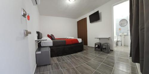 a bedroom with a bed and a television in it at Book & Sleep Cancun in Cancún