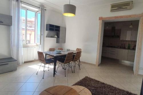 a kitchen and dining room with a table and chairs at La Torretta Nettuno in Nettuno