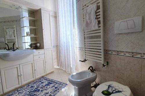 a bathroom with a toilet and a sink at La Torretta Nettuno in Nettuno