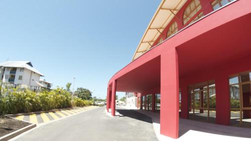 a red building next to a street at Mercure Cayenne Royal Amazonia in Cayenne