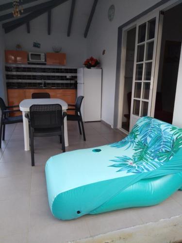 a large inflatable bed in a room with a table at Résidence Fleur de Lys 1 in Petit-Bourg