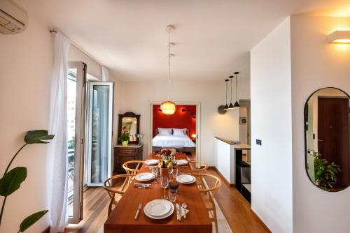 a dining room with a table and a bed at Airy Seafront 1920s Apartment in Split