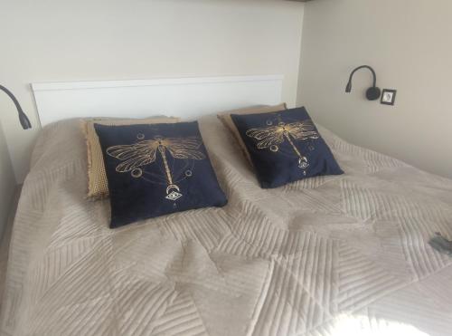 a bed with two pillows on top of it at Apartament HARMATA Jagiellońska 42 new 2023 in Warsaw