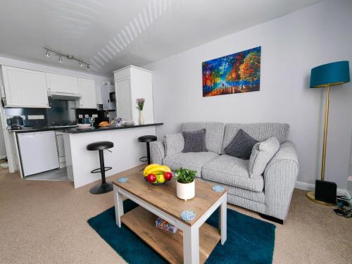 a living room with a couch and a table at Dove Apartments in Oxford