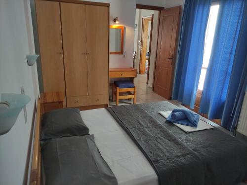 a bedroom with a bed with a hat on it at Mata's House in Skiathos Town