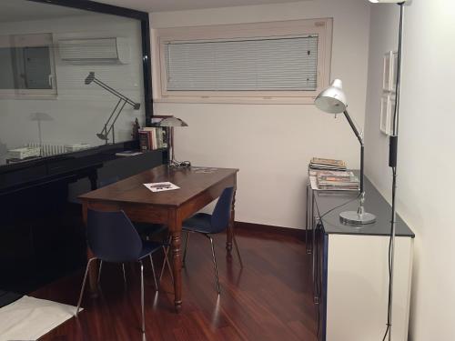 a room with a desk and two chairs and a table at Villa Mezzacollina in Battifolle