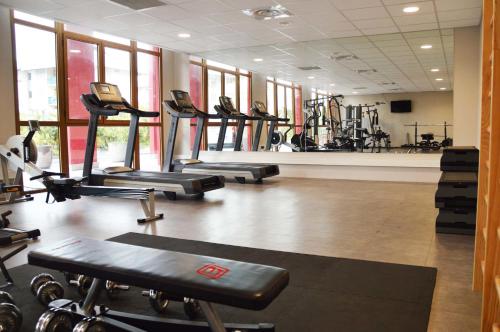 a gym with a row of treadmills and machines at Mercure Cayenne Royal Amazonia in Cayenne