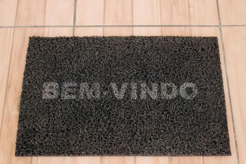 a black rug with the wordenna on the floor at Ótimo custo benefício 2km centro wifi fogão lenha in Lages