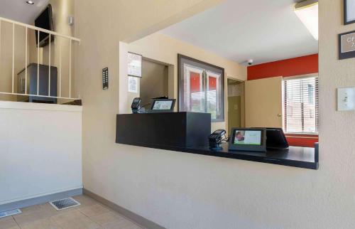 a lobby with a reception desk with a phone at Suburban Studios Louisville East in Louisville