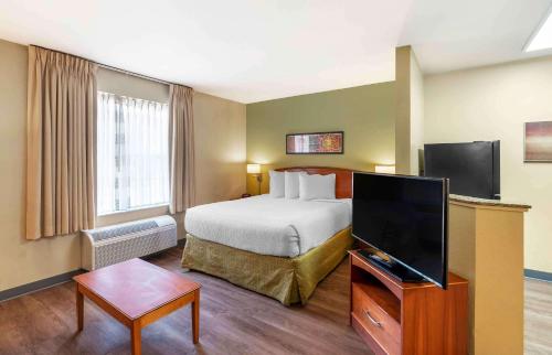 a hotel room with a bed and a flat screen tv at Extended Stay America Suites - Norfolk - Virginia Beach in Virginia Beach