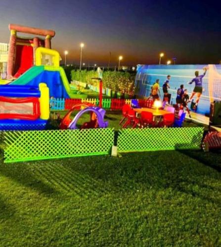 a childrens play park with a playground with a play set at شاليه للايجار 3 غرف مكيفات بقرية جراند هيلز الساحل الشمالى بإطلاله مباشره على البول in Qaryat Shurūq