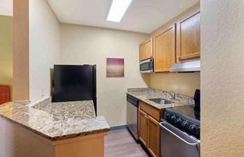 a small kitchen with a sink and a stove at Extended Stay America Suites - Norfolk - Virginia Beach in Virginia Beach