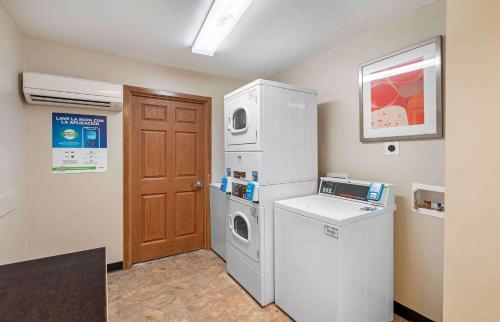 a laundry room with a refrigerator and a washer and dryer at Extended Stay America Suites - Norfolk - Virginia Beach in Virginia Beach