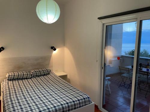 a bedroom with a bed and a view of a balcony at Apartamento Playa Chica Tenerife in San Andrés