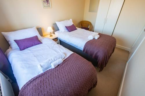 two beds sitting next to each other in a room at Serene Sands in Felixstowe