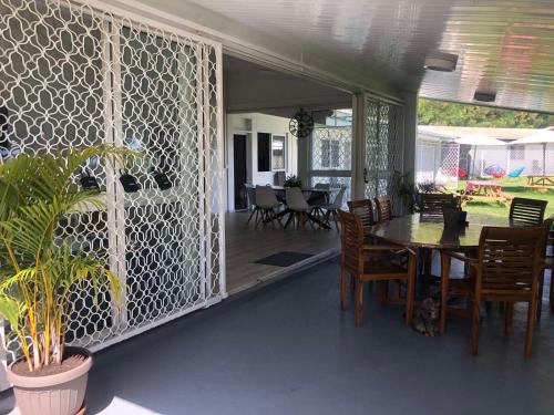 a dining room with a table and chairs on a patio at Temana Airport Faa'a,Tahiti in Faaa