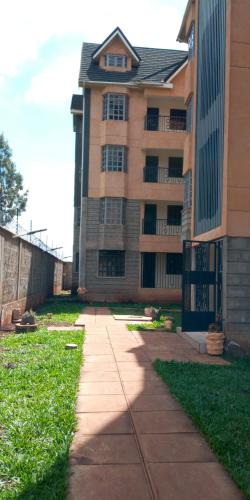 a building with a sidewalk in front of a building at The Arches Accola in Nairobi