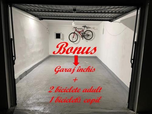 a bike in a garage with a sign on it at Pyky in Baia Mare