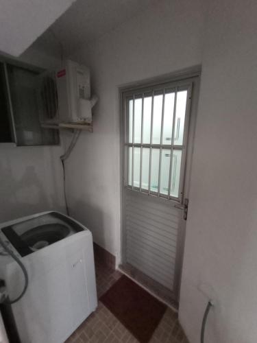 a small bathroom with a toilet and a window at Residencial Garcia in Florianópolis