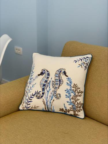 a pillow with two se snakes on it sitting on a chair at Popi in Budva
