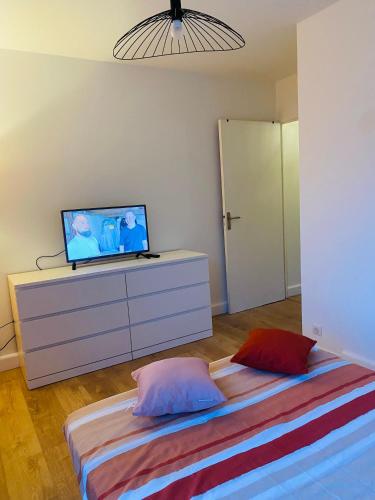 a bedroom with a bed and a tv on a dresser at Lisandrina in Ajaccio