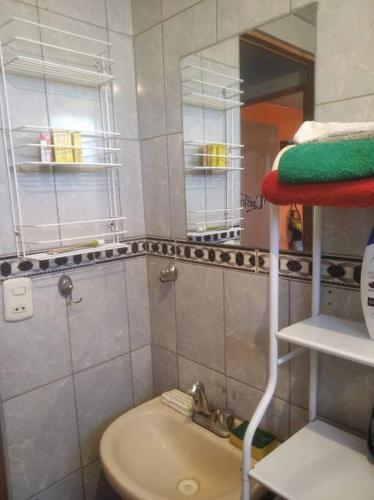 a small bathroom with a sink and a mirror at Jack Appart (departamento 2 cuartos y terraza) in Arequipa